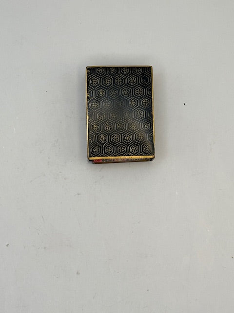 Reverse of the cloisonne cover with a gold honeycomb hexagon pattern on black enamel