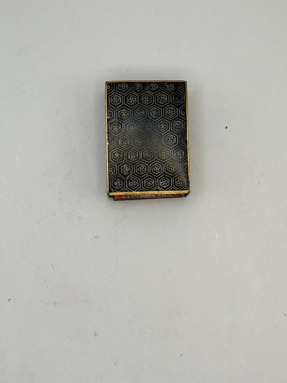 Reverse of the cloisonne cover with a gold honeycomb hexagon pattern on black enamel