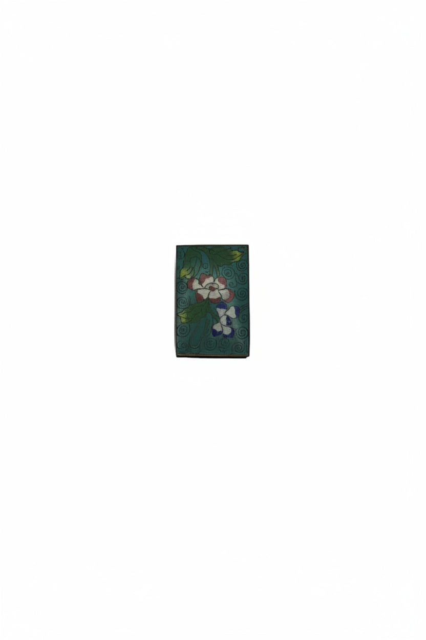 Reverse of the aqua cloisonne matchbox cover with a red bloom and blue floret on teal enamel
