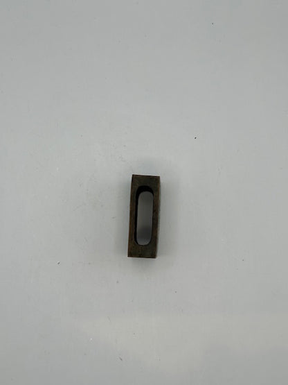 Open brass matchbox-cover frame showing the hollow underside that holds a matchbox