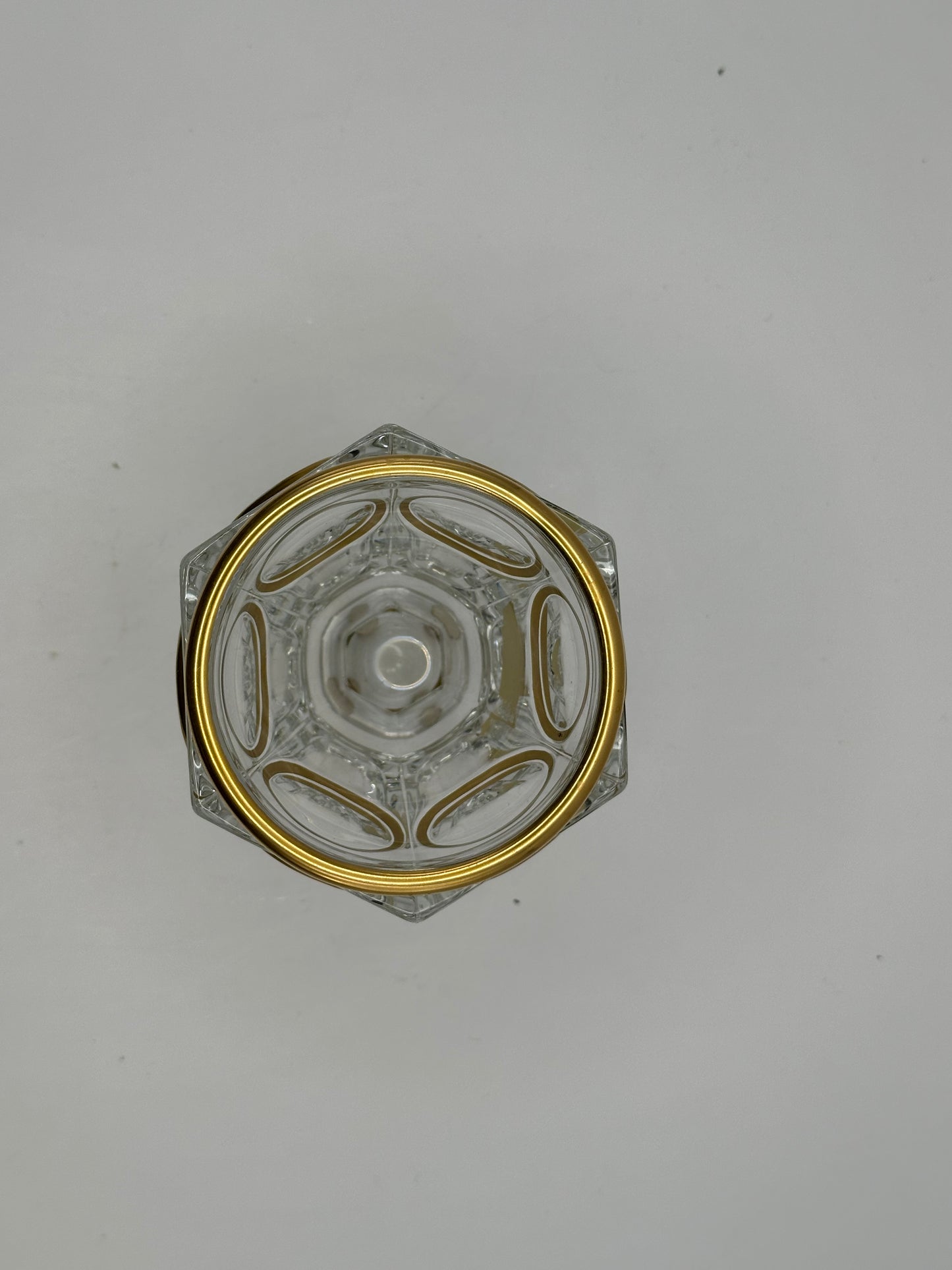 Top-down view of the Baccarat crystal vase's hexagonal foot with radiating gilt panels around the gold rim
