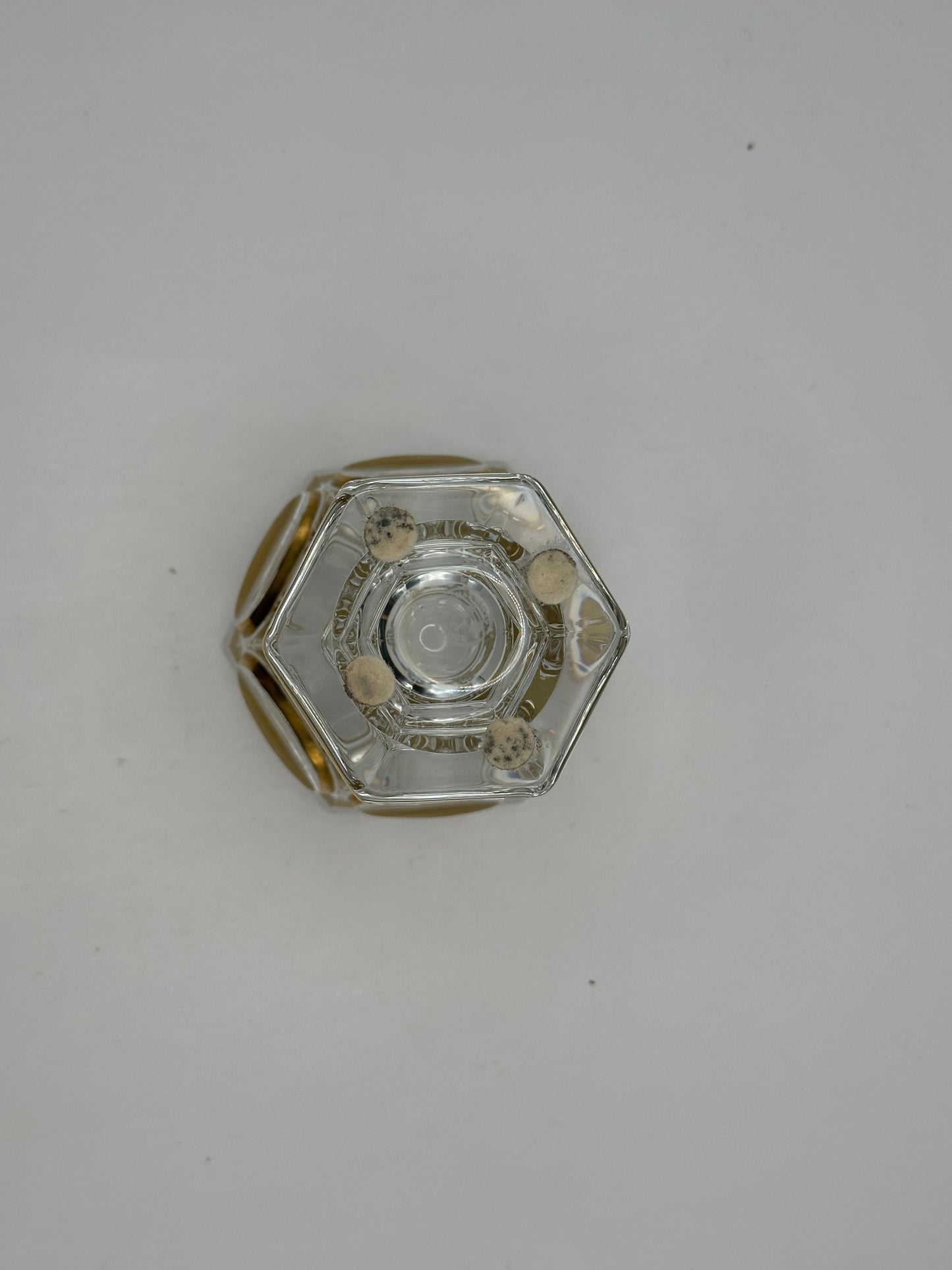 Underside of the Baccarat crystal vase showing the hexagonal foot and concentric gilt rings on the base