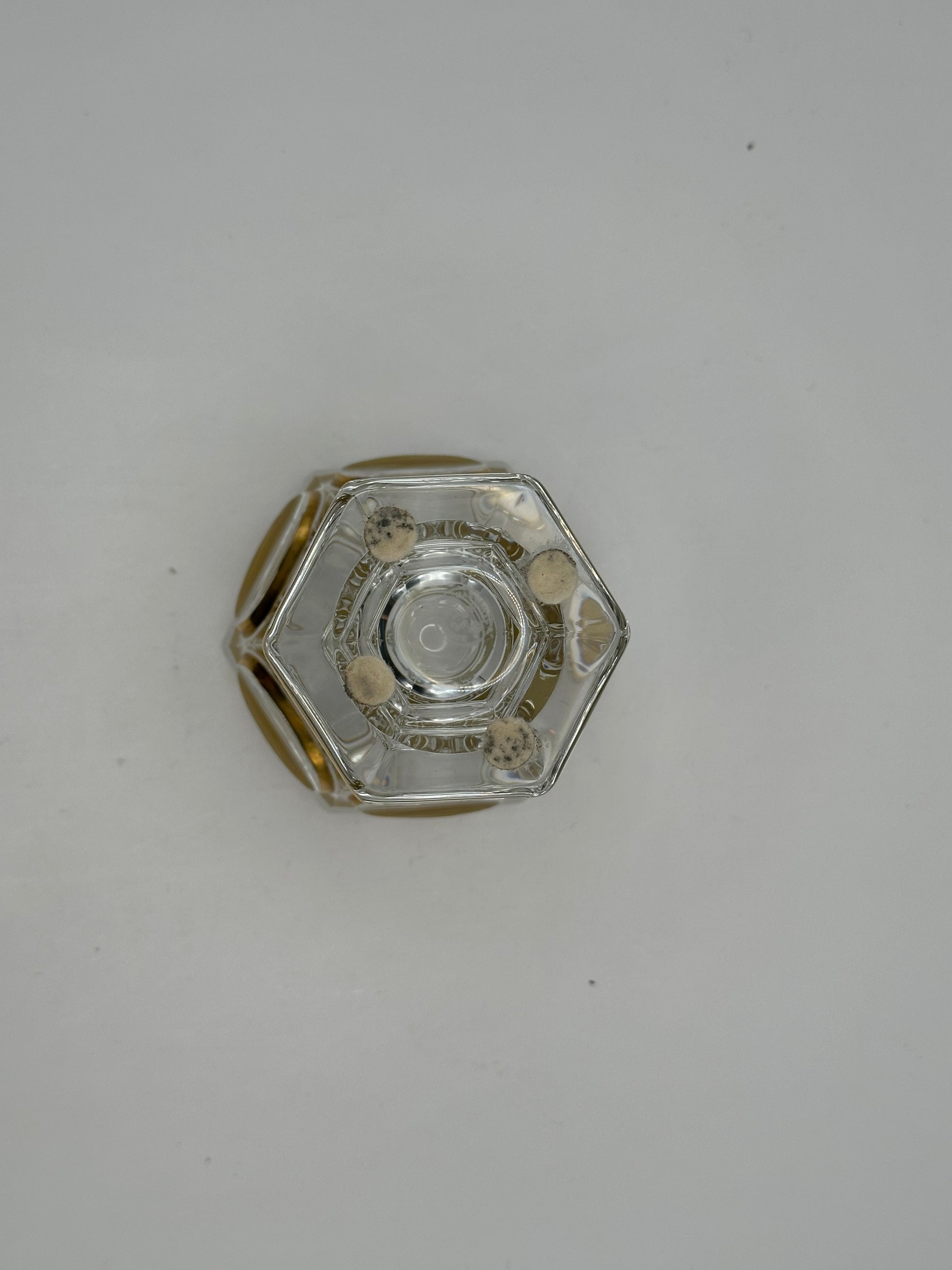 Underside of the Baccarat crystal vase showing the hexagonal foot and concentric gilt rings on the base