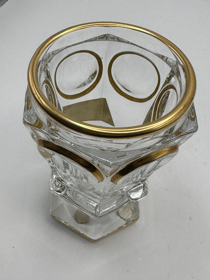 Looking down into the Baccarat crystal vase, showing gilt-ringed rim and faceted gold-decorated walls