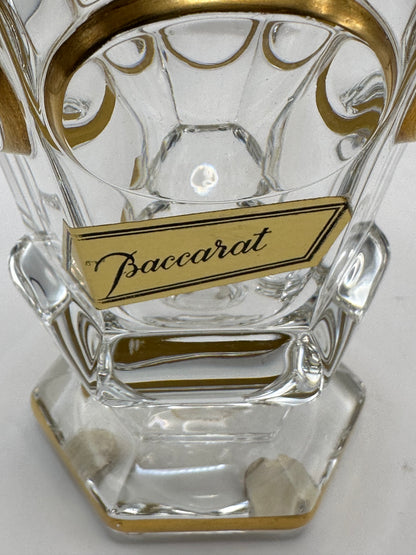 Close-up of the gold paper Baccarat maker's label affixed to the lower body of the crystal vase