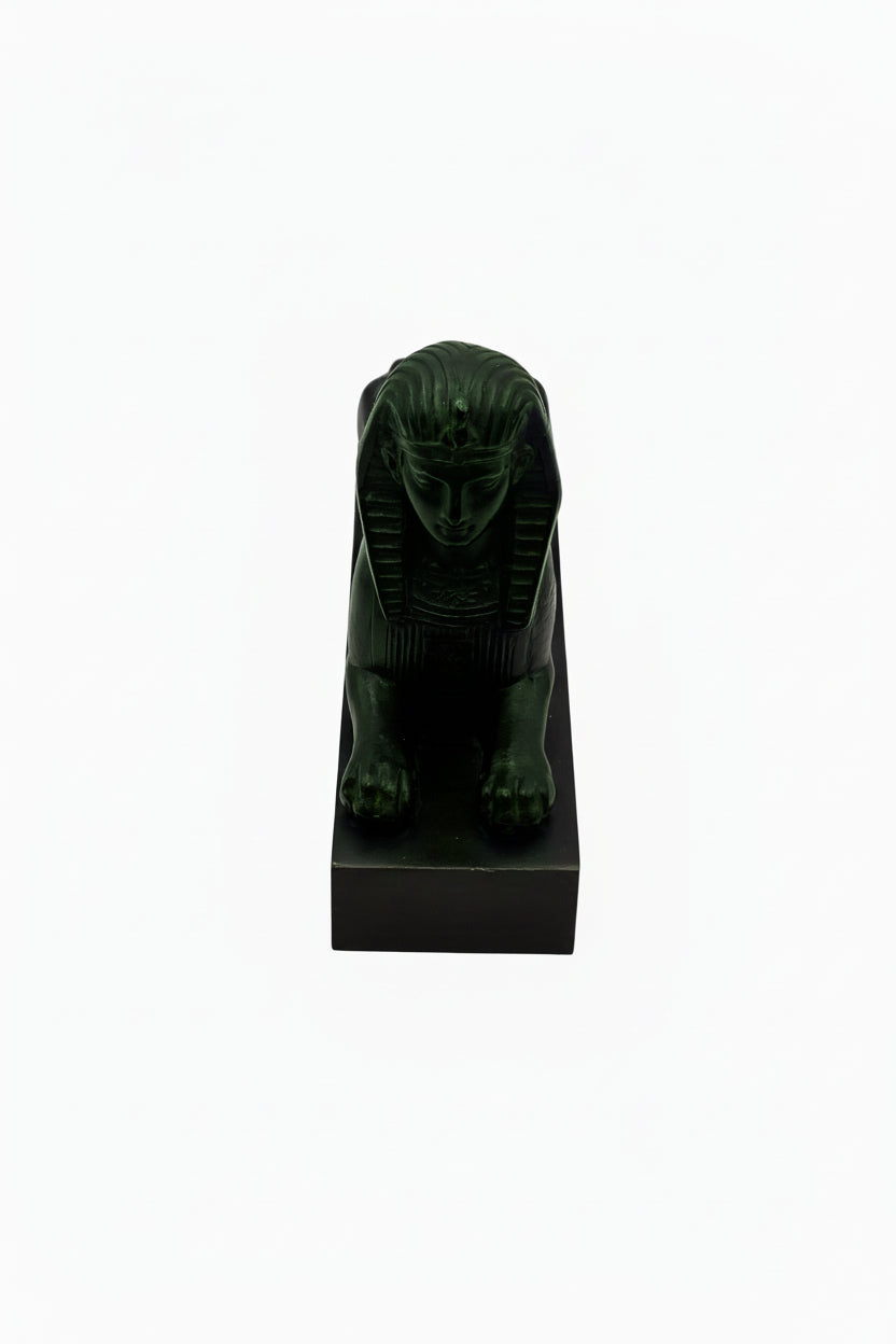 Vintage Egyptian Revival sphinx in dark green-black stone, front view on black base
