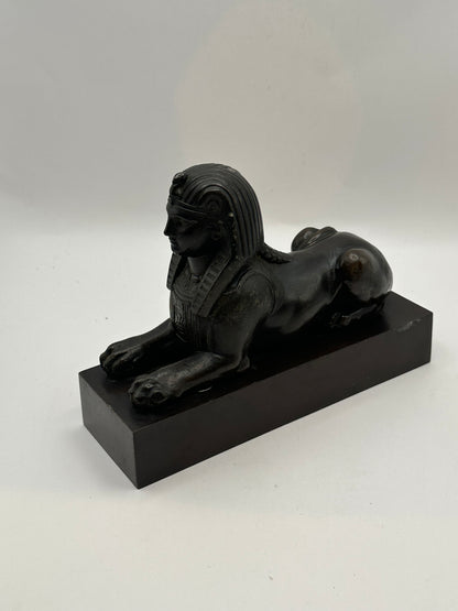 Vintage Egyptian Revival bronze sphinx, angled side view on black plinth