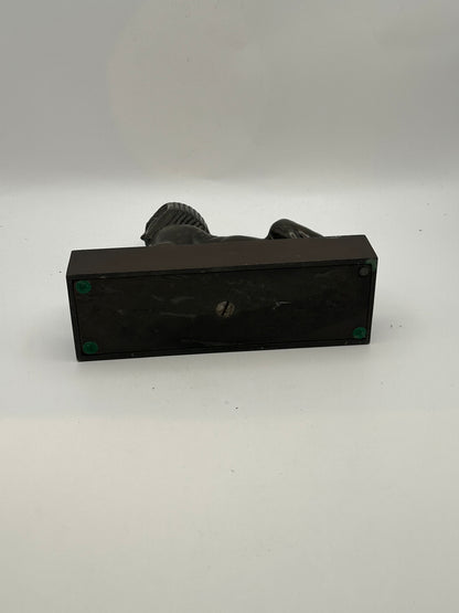 Underside of vintage bronze sphinx statue showing black base with felt pads and screw