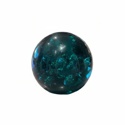 MCM controlled-bubble teal glass sphere paperweight, front view on white background
