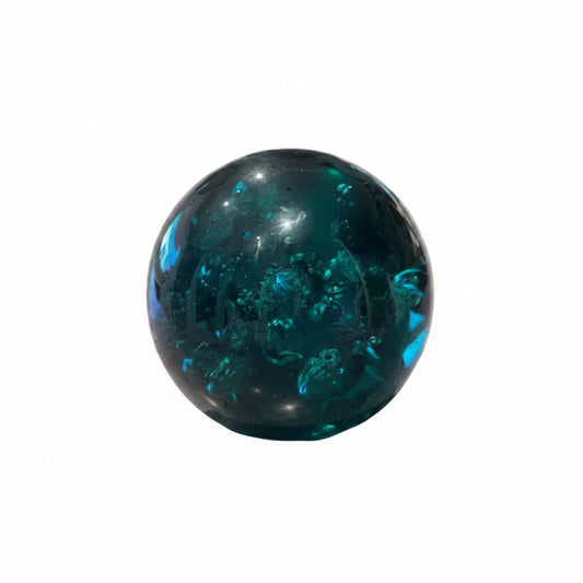 MCM controlled-bubble teal glass sphere paperweight, front view on white background