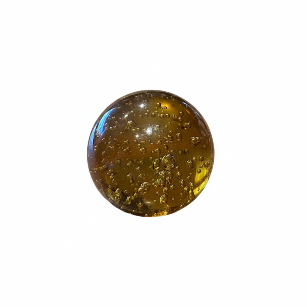 MCM amber controlled-bubble glass sphere with suspended bubbles, on white background