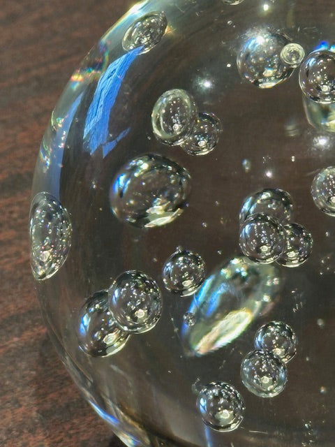 Close-up of the suspended air bubbles inside the clear glass sphere