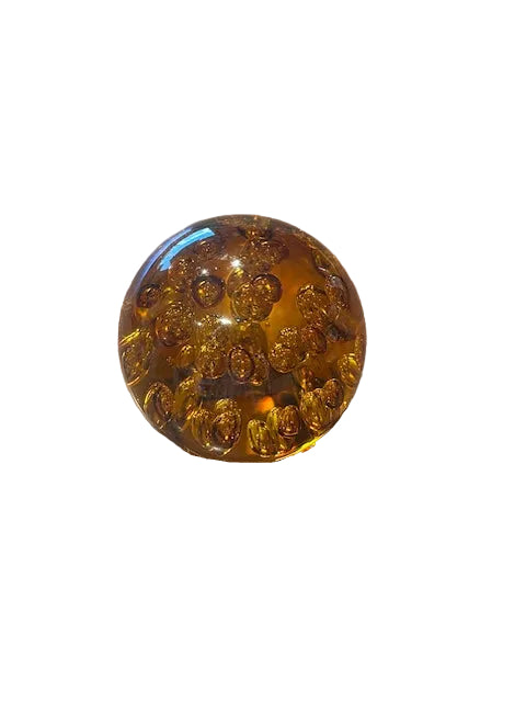 MCM amber bubble glass sphere, angled view showing suspended bubbles on white background