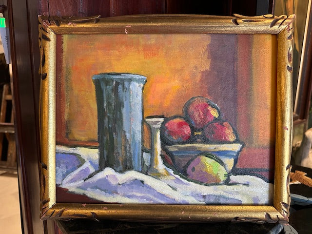 Front view of vintage framed still life painting against a dark background