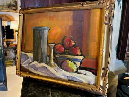 Vintage framed still life painting displayed upright, angled view in a room setting