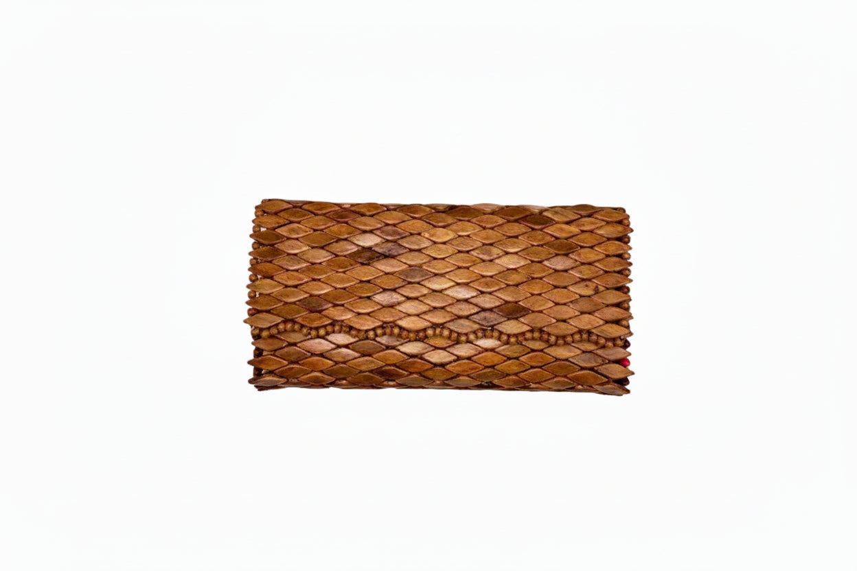 Top-down view of Ma'aM Kind woven wood clutch with tan scale-tiled surface