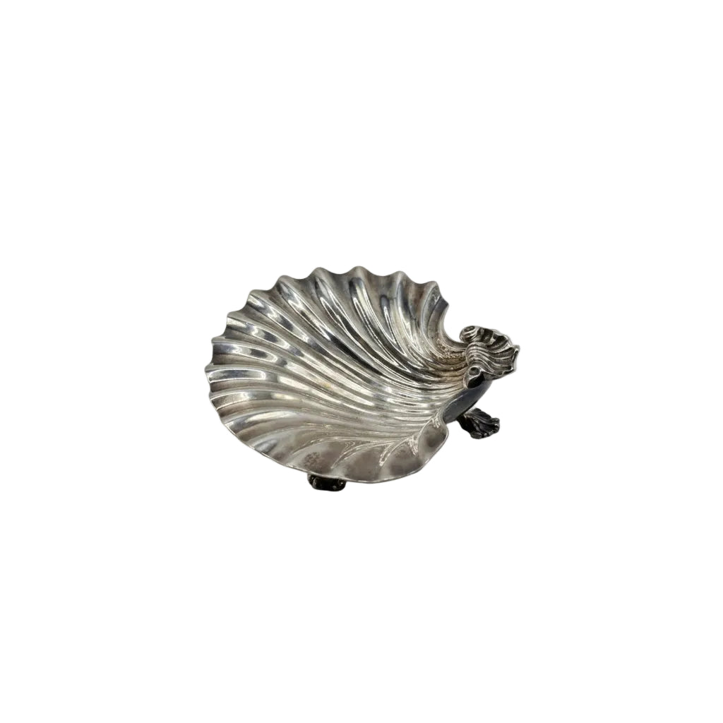 Vintage silver plate shell dish, angled view on claw feet with figural dolphin handle