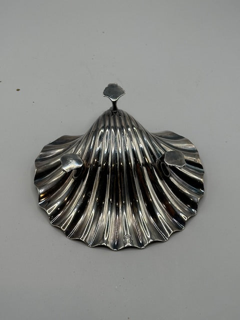 Underside of the vintage silver plate shell dish, top view showing fluted scallop and feet