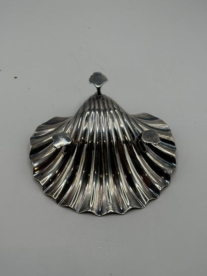 Underside of the vintage silver plate shell dish, top view showing fluted scallop and feet