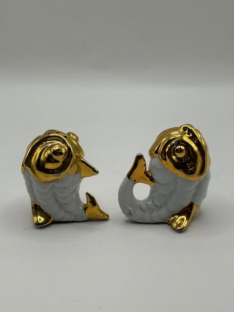 Vintage fish salt and pepper set, the two gold-and-white porcelain fish standing upright facing each other