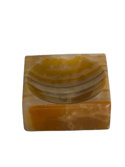 Vintage onyx salt cellar, front view showing the carved salt well in banded amber stone