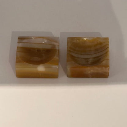 Vintage onyx salt cellars, pair shown at an angle highlighting the banded stone