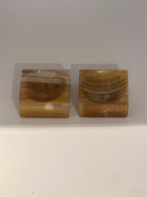 Vintage onyx salt cellars, pair front view showing the carved salt wells