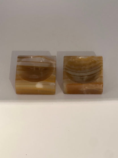 Vintage onyx salt cellars, pair front view showing the carved salt wells
