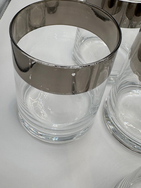 Close-up of one MCM rocks glass rim with its wide polished silver band