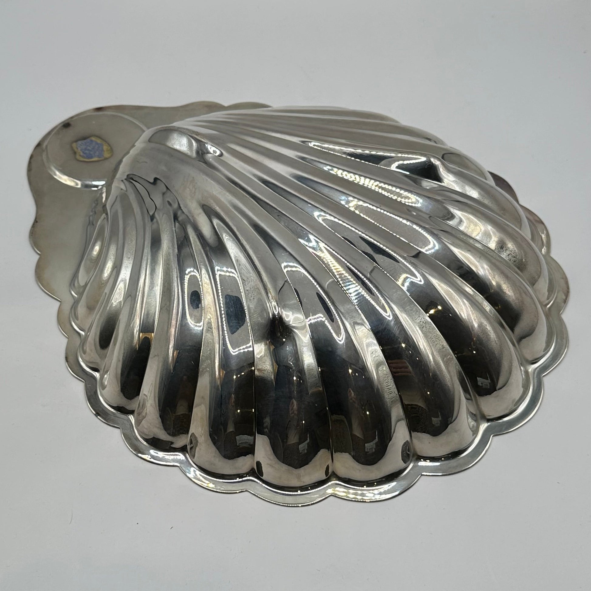 Underside of the Rogers silver plate shell server, ribbed scallop exterior with small label remnant