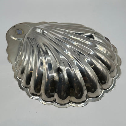 Underside of the Rogers silver plate shell server, ribbed scallop exterior with small label remnant