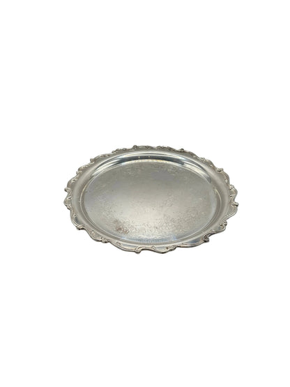 Silver-plate serving tray, top view of scalloped ornate rim