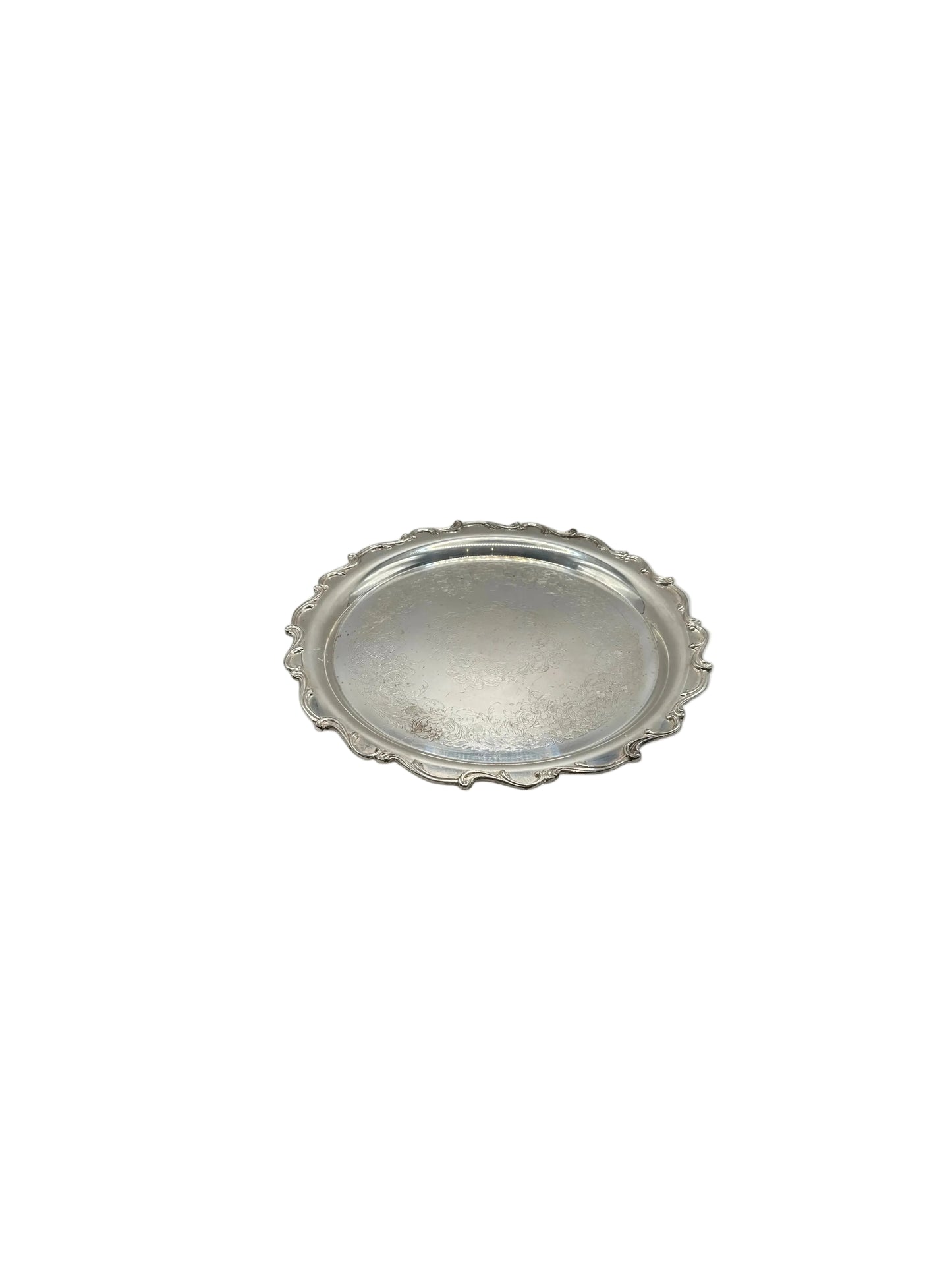 Vintage silver-plate round serving tray with scalloped border, angled view