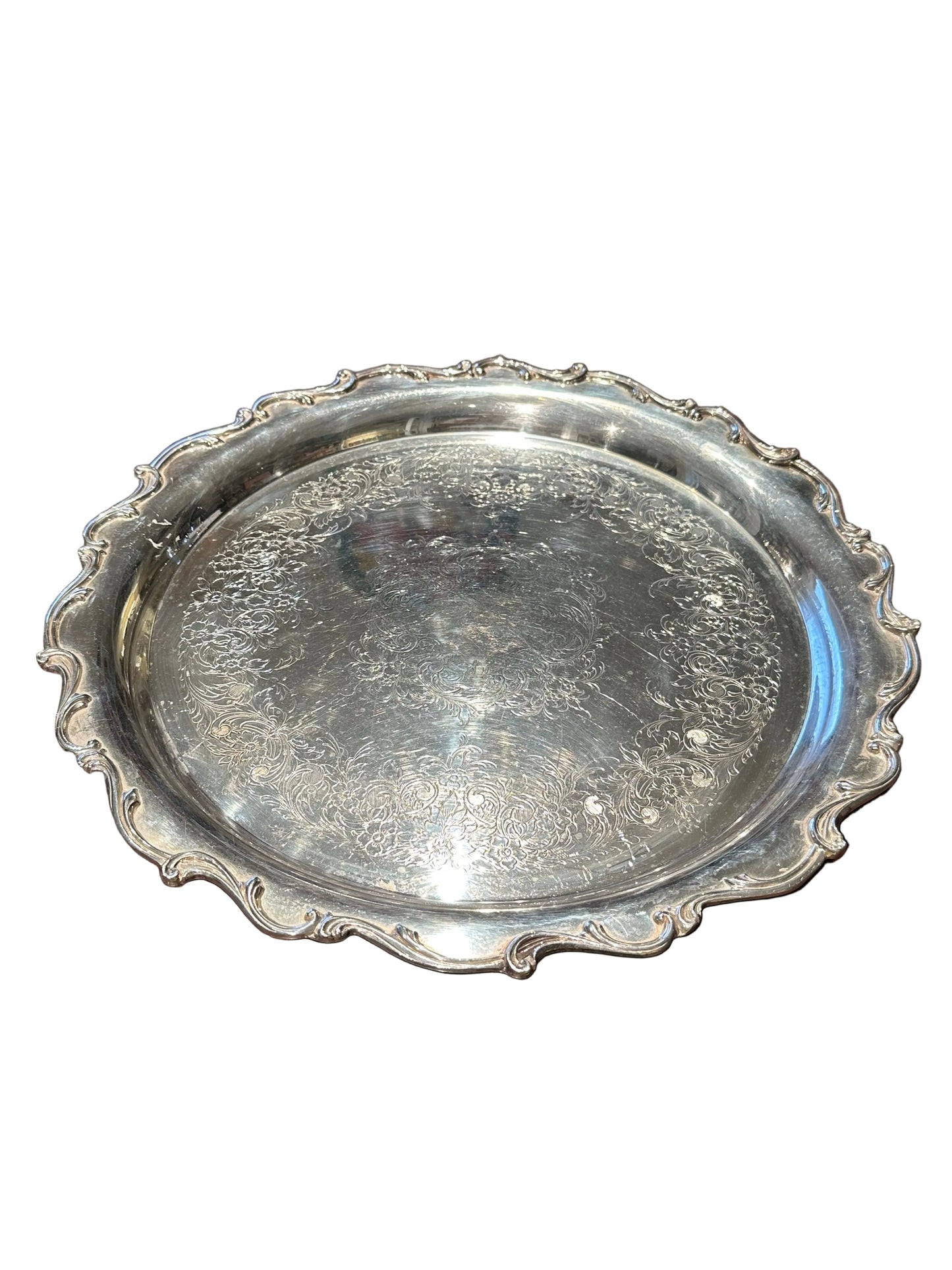 Ornate engraved silver-plate rotating serving tray, three-quarter view