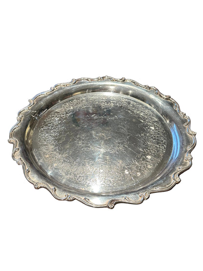 Ornate engraved silver-plate rotating serving tray, three-quarter view