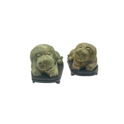 Pair of vintage green veined stone foo dogs on dark wood bases, front view