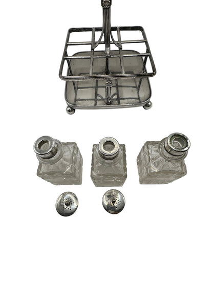 Antique cruet set, silver caddy with three cut-glass bottles and two pierced shaker tops