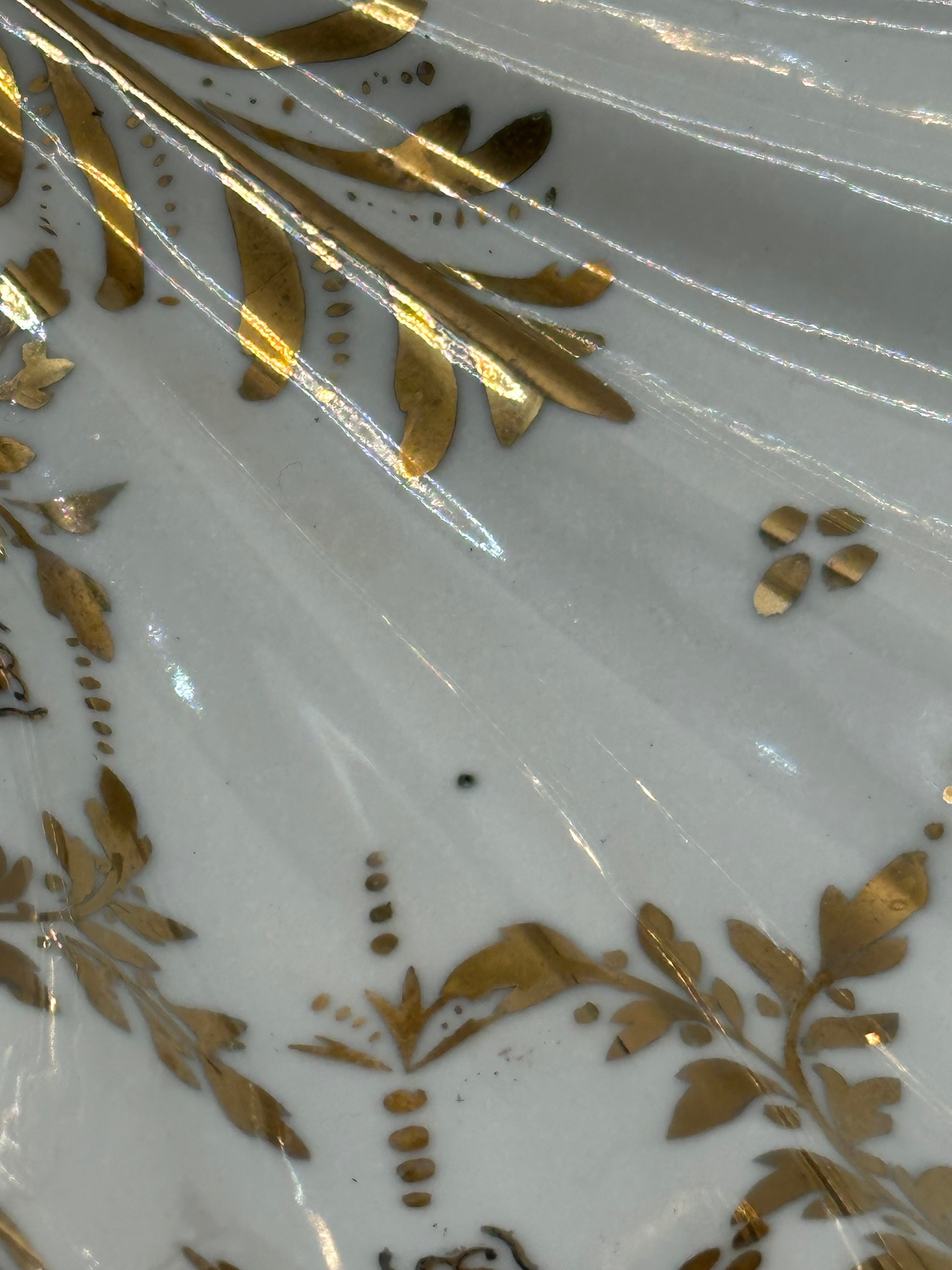 Close-up of the Vintage Limoges shell dish's gilt hand-painted floral and leaf decoration