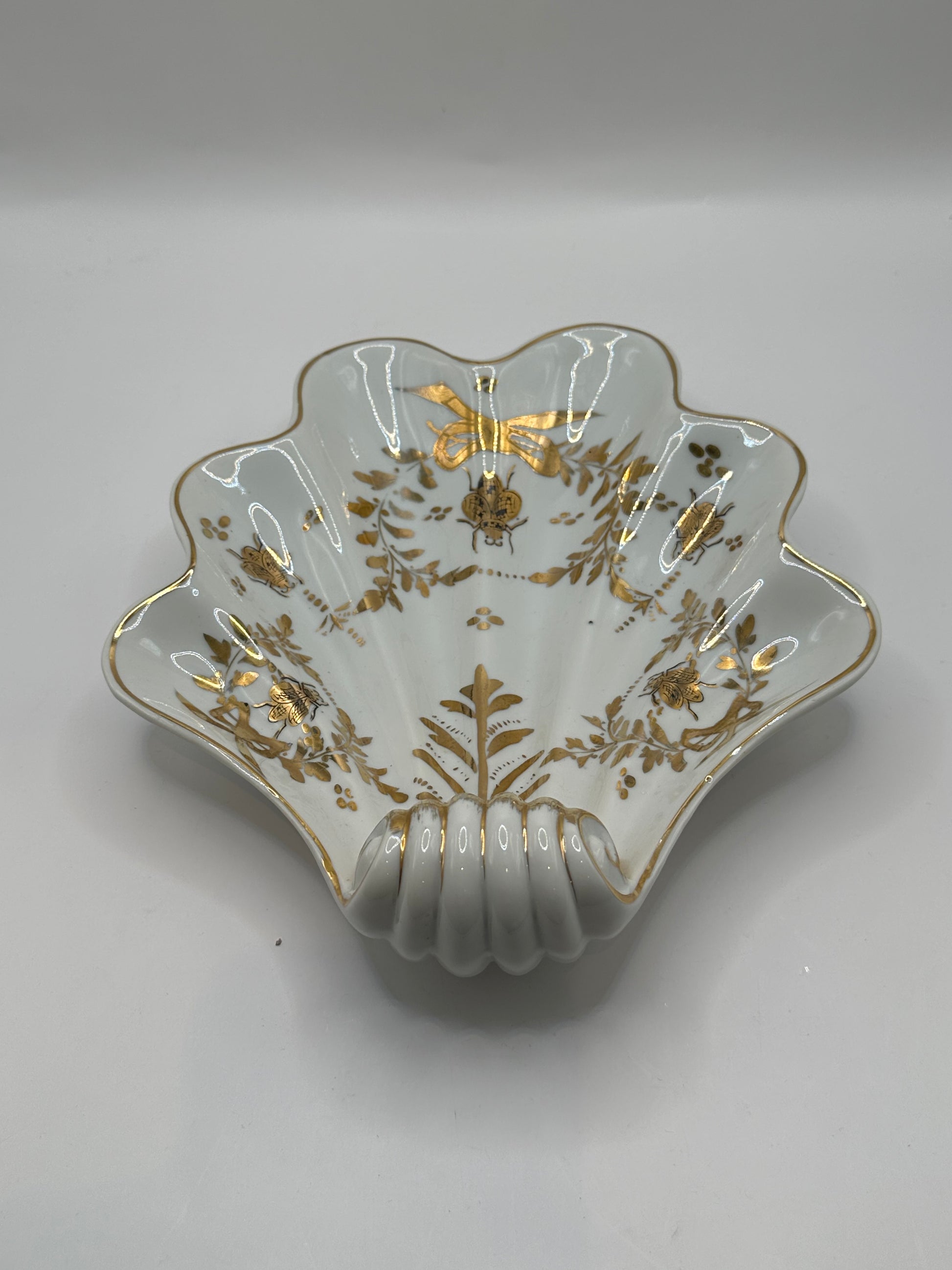 Vintage Limoges shell dish, front view of bowl interior with gilt bee, ribbon and foliage motifs