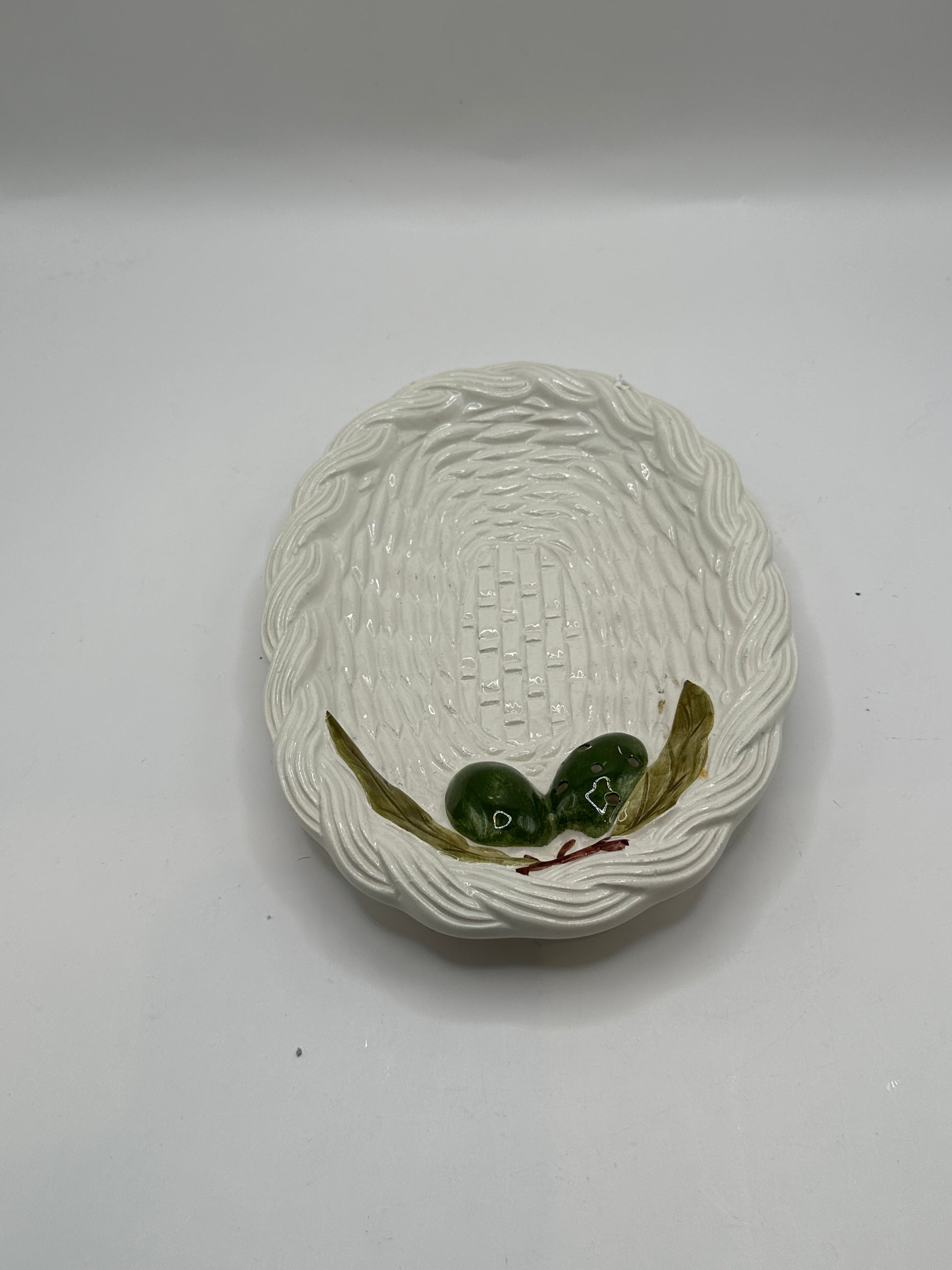 Italian ceramic olive dish, top view of basketweave well and green olive-and-leaf relief