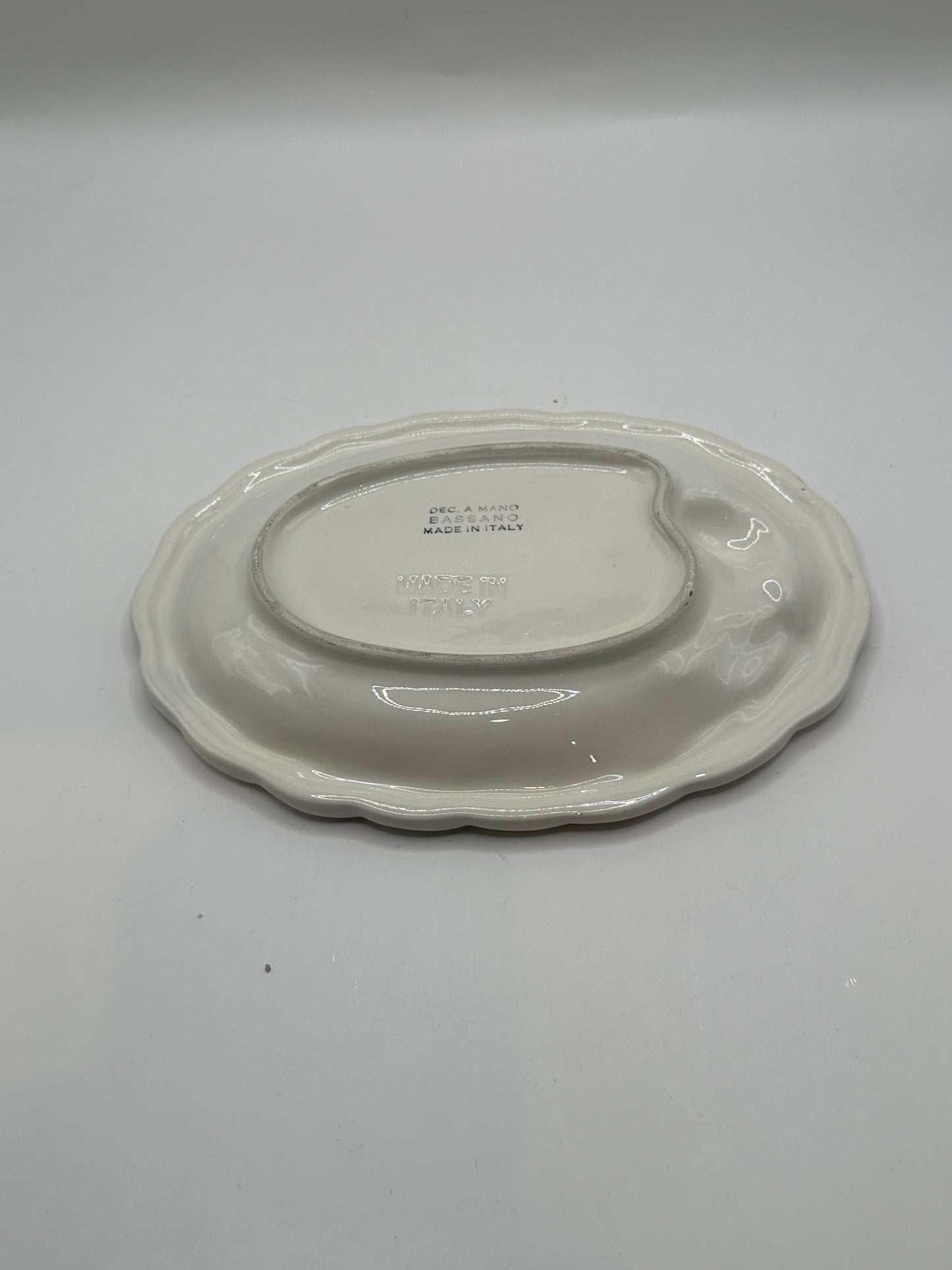Italian ceramic olive dish underside with impressed Bassano Made in Italy maker's mark