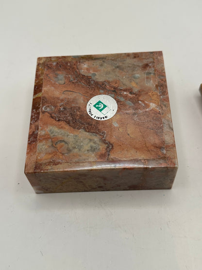 Closed rose marble box with a round Marble Products label on the lid