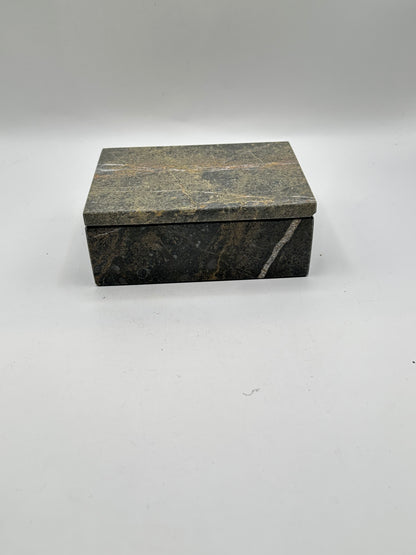 Closed gray stone lidded box, three-quarter view with white veining