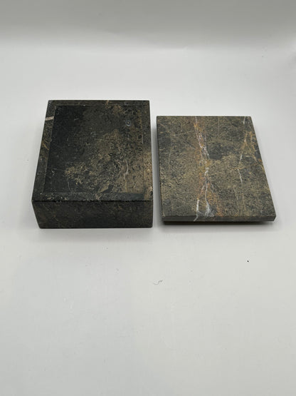 Gray stone box with lid removed beside it, showing veined underside