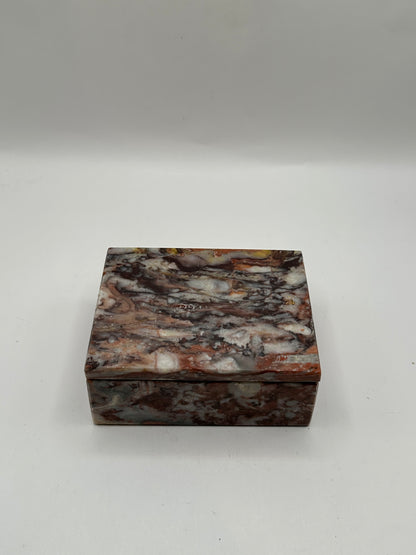 Closed rust multi marble lidded box, front view of mottled veining