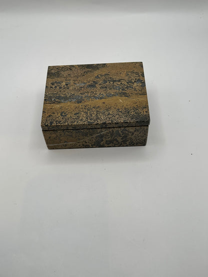 Closed brown multi stone box, three-quarter view of polished speckled surface