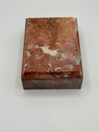 Closed rust marble box, angled top view of mottled grain