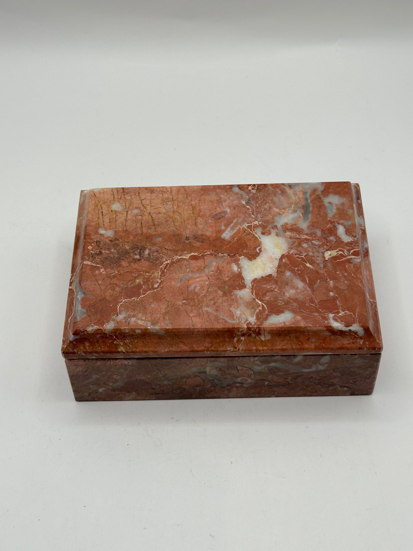 Rust marble lidded box, three-quarter view of red and cream veining