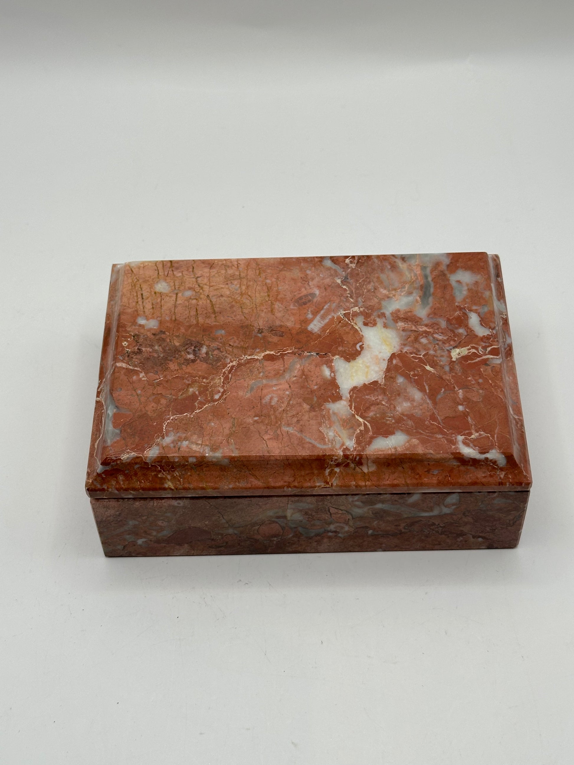Rust marble lidded box, three-quarter view of red and cream veining