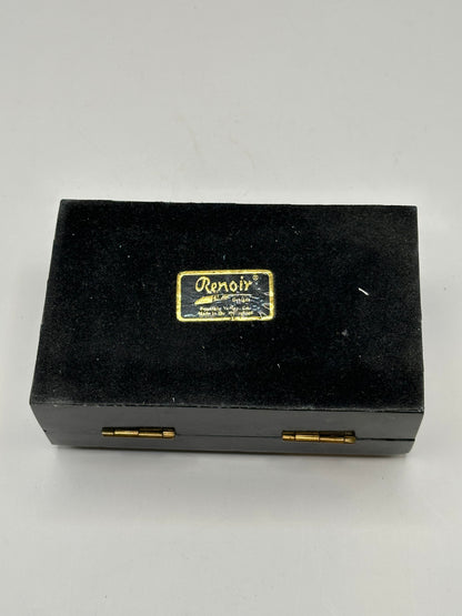 Closed black tessellated stone box, top-down view of tiled pattern